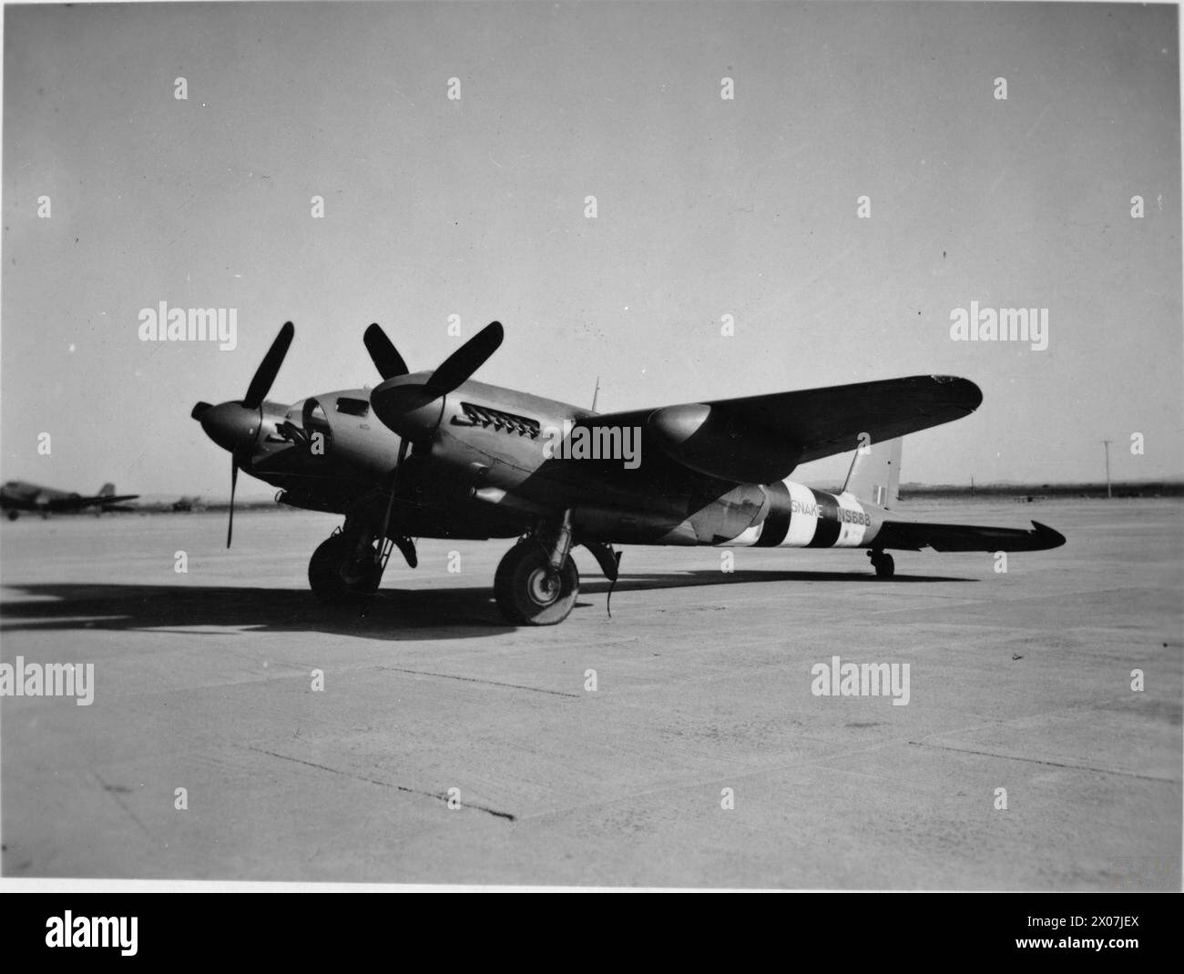 ROYAL AIR FORCE OPERATIONS IN THE FAR EAST, 1941-1945. - De Havilland Mosquito PR Mark XVI, NS688 'SNAKE', on the ground at Karachi, India, following a record-breaking flight from the United Kingdom. The pilot, Flight Lieutenant J Linton, and his navigator, Warrant Officer E J Goudie, covered the distance in an overall time of 16 hours 46 minutes, (with stops at El Adem, Libya, and Shaibah), to beat the existing record by 5 hours and 27 minutes. The flight was undertaken to test the practicability of RAF Transport Command using the Mosquito for a fast freight service between Britain and India. Stock Photo