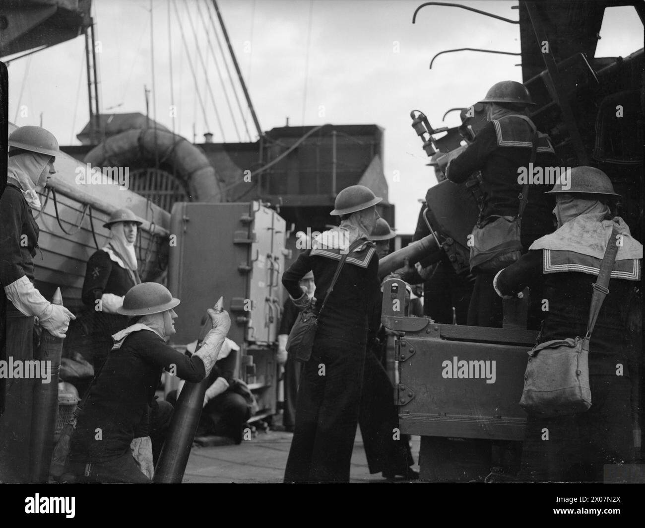 The 4-inch High Angle Anti-Aircraft gun crew operates aboard HMS ...