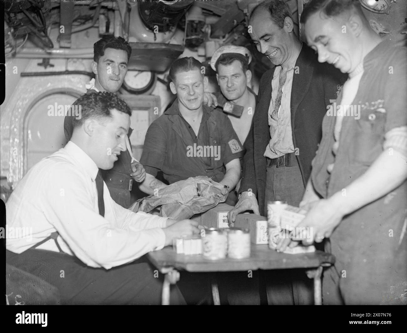 Royal Navy submarine crew members drew their cigarette rations at Malta  prior to departing on a Mediterranean patrol during World War II Stock  Photo