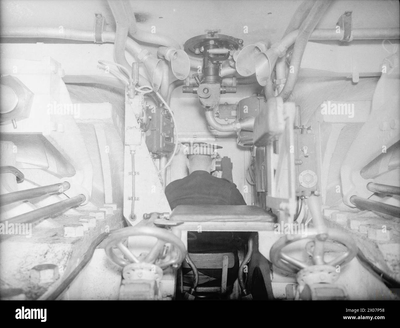 Gunners operate the turret trainer inside the quadruple gun turret ...