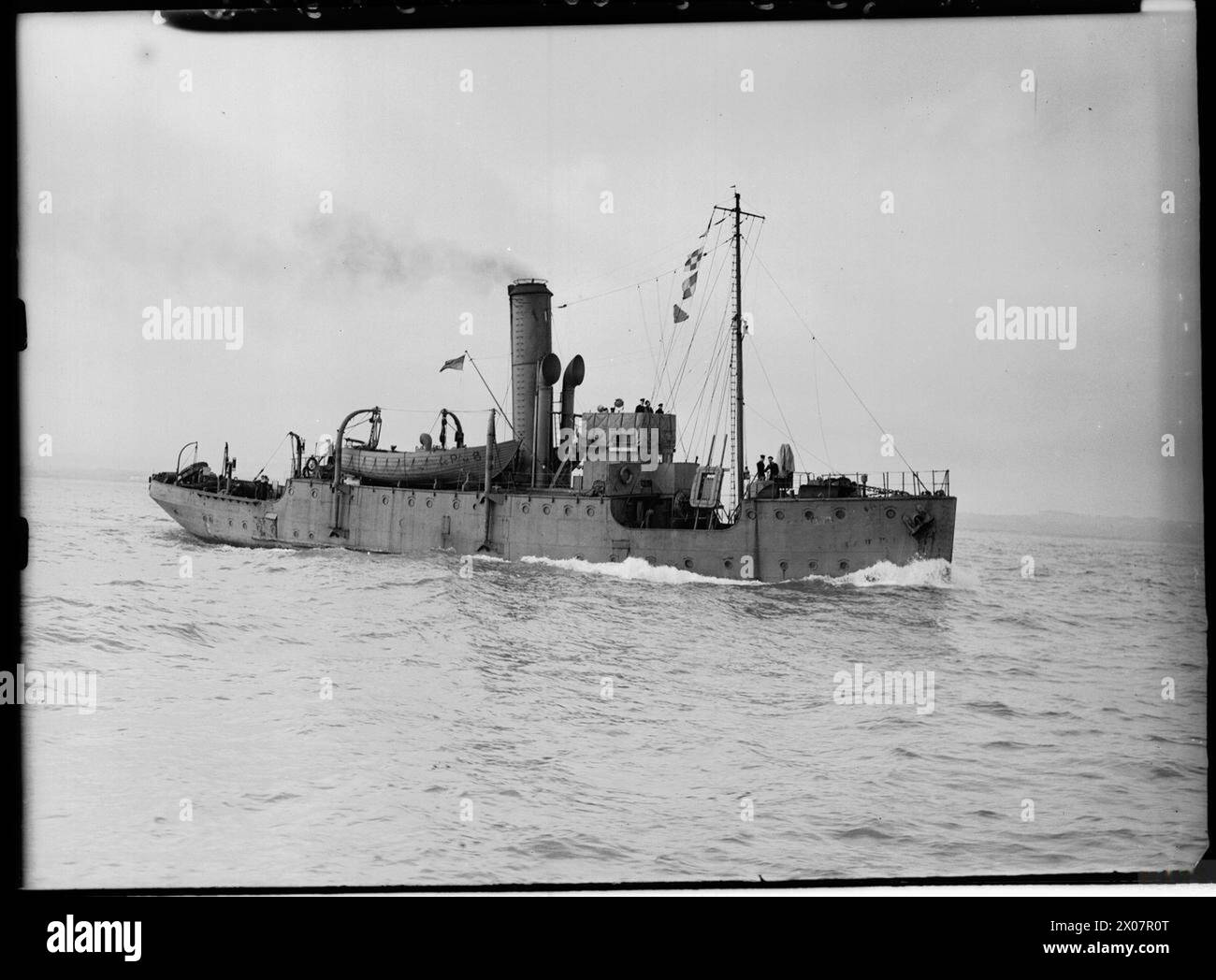 HMS Quentin Roosevelt is underway at sea with crew on deck conducting ...