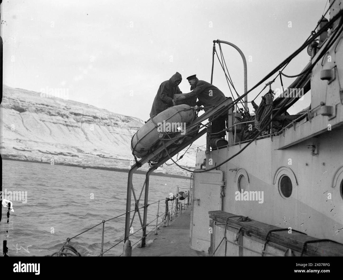 Two sailors on HMS Eskimo attached a new Carley Float life boat after ...