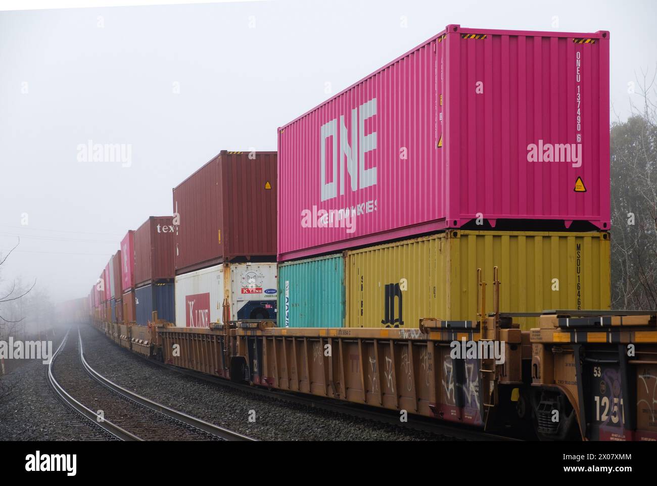 Freight train is shipping cargo containers on a railway in Ontario Province. Stock Photo
