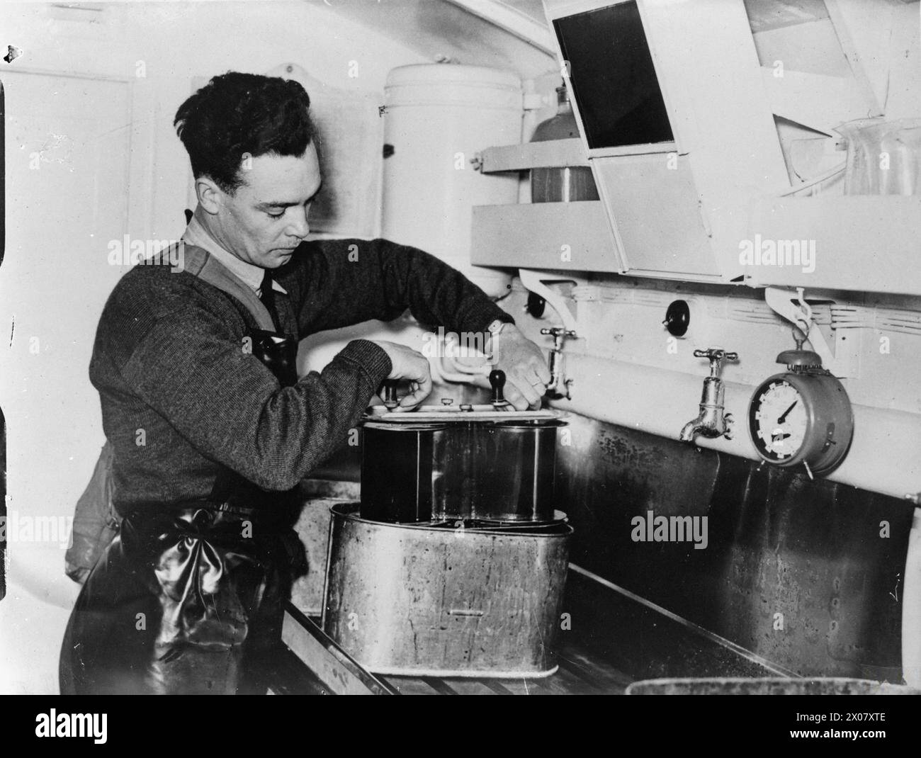 ROYAL AIR FORCE: FRANCE, 1939-1940. - A photographer removes developed aerial reconnaissance film (taken by an F.24 aerial camera) from a developing tank in a Mobile Darkrooms tender at the Headquarters of No. 71 Wing RAF, Bétheniville Stock Photo
