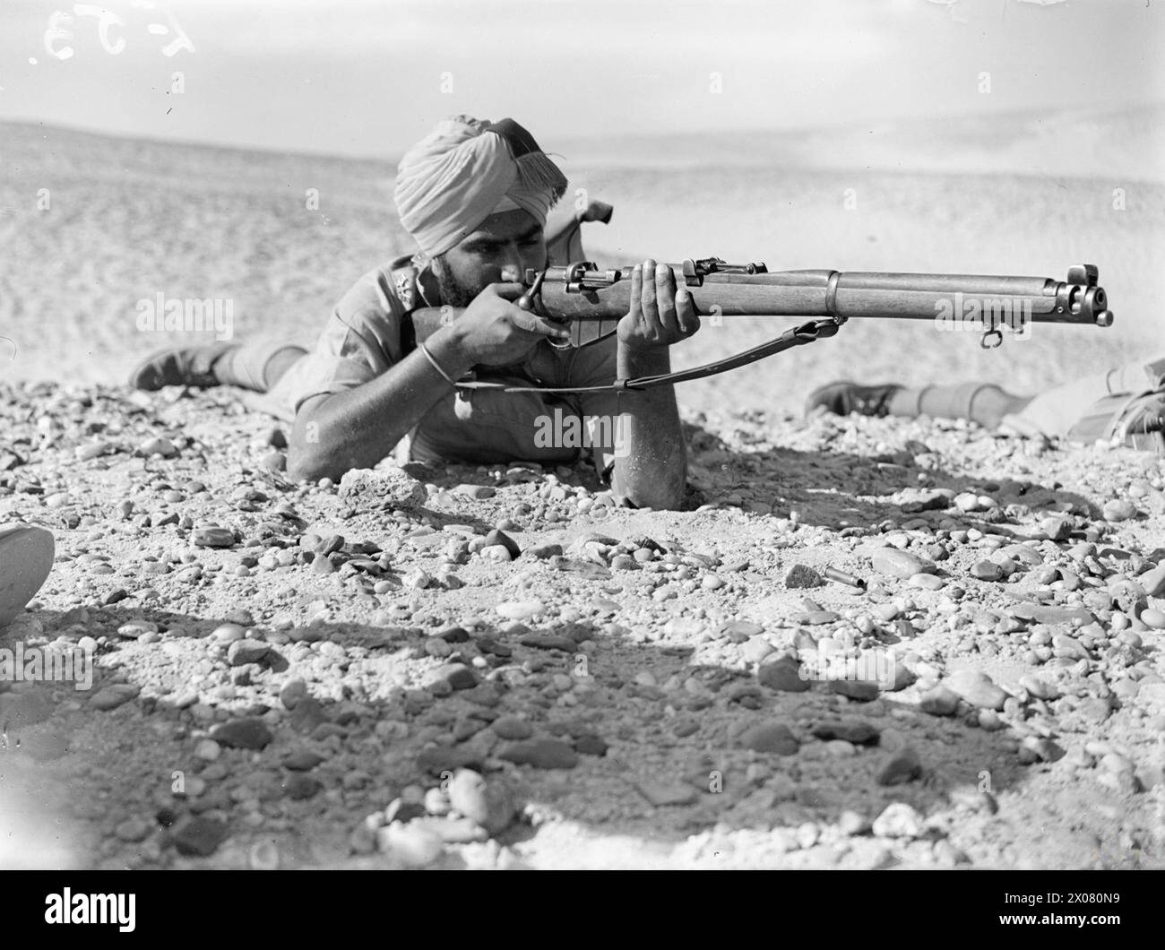 An Indian rifleman of the Commonwealth forces fires a SMLE Mk III in ...