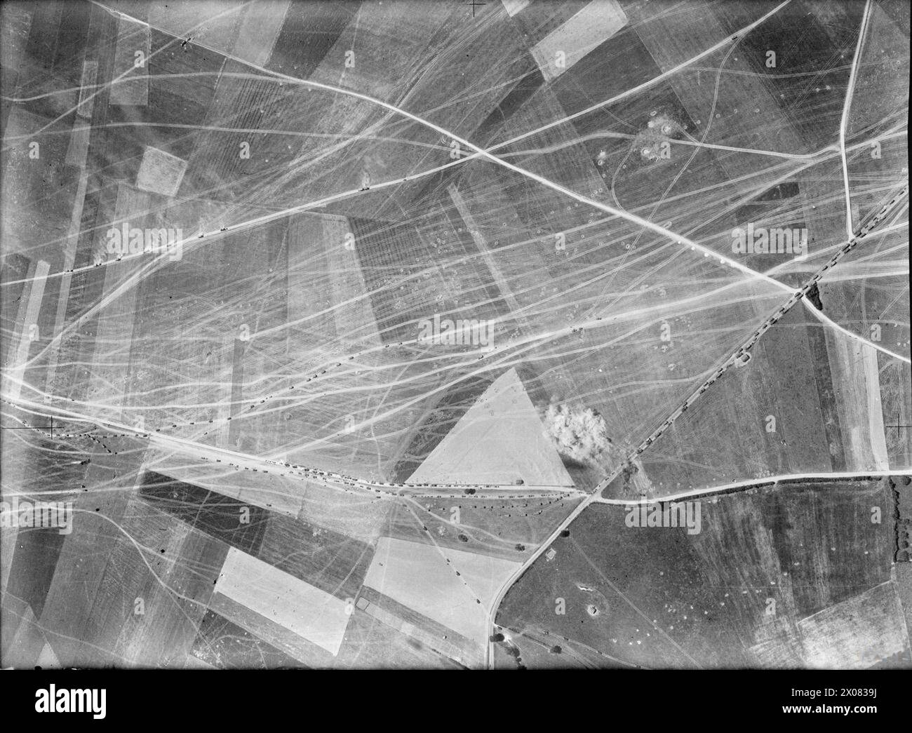 ROYAL AIR FORCE BOMBER COMMAND, 1939-1941. - Vertical aerial photograph showing bombs from Bristol Blenheims of No. 82 Squadron RAF exploding near a large concentration of German tanks, guns, ammunition limbers and motorised transport, advancing towards Paris on a road and across fields near Montagne-Fayel  Royal Air Force, Maintenance Unit, 85, German Army (Third Reich) Stock Photo