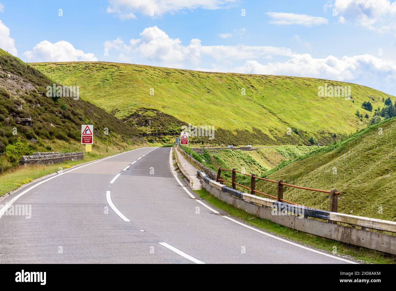 Dangerous curve along a mountain pass road in Englang on a sunny summer day Stock Photo