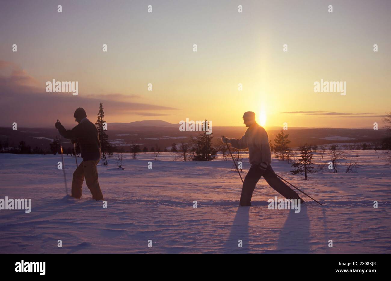 Skiing at sunset Stock Photo