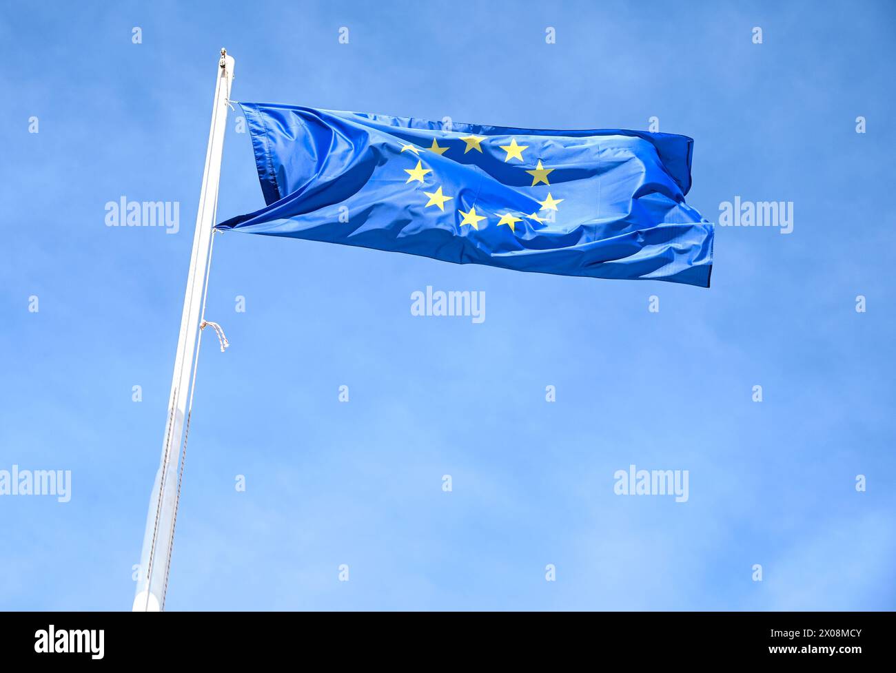EU flag waving in the wind against blue sky. Flag of European Union on ...