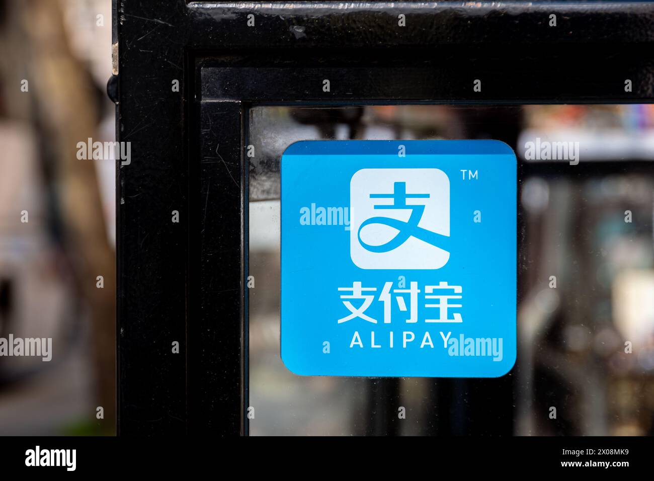 Sticker on a store window indicating acceptance of Alipay payments. Alipay is a international third-party mobile and online payment platform Stock Photo