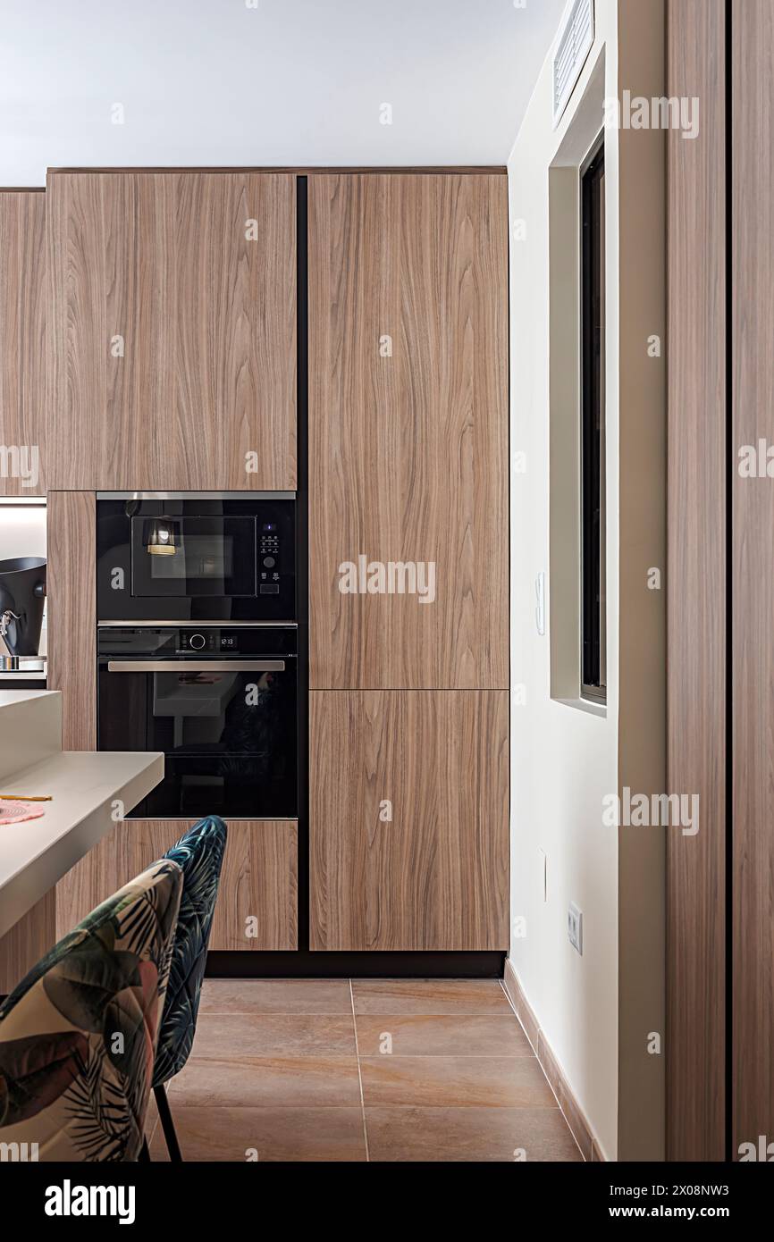 A vertical image displaying a contemporary kitchen design with sleek ...