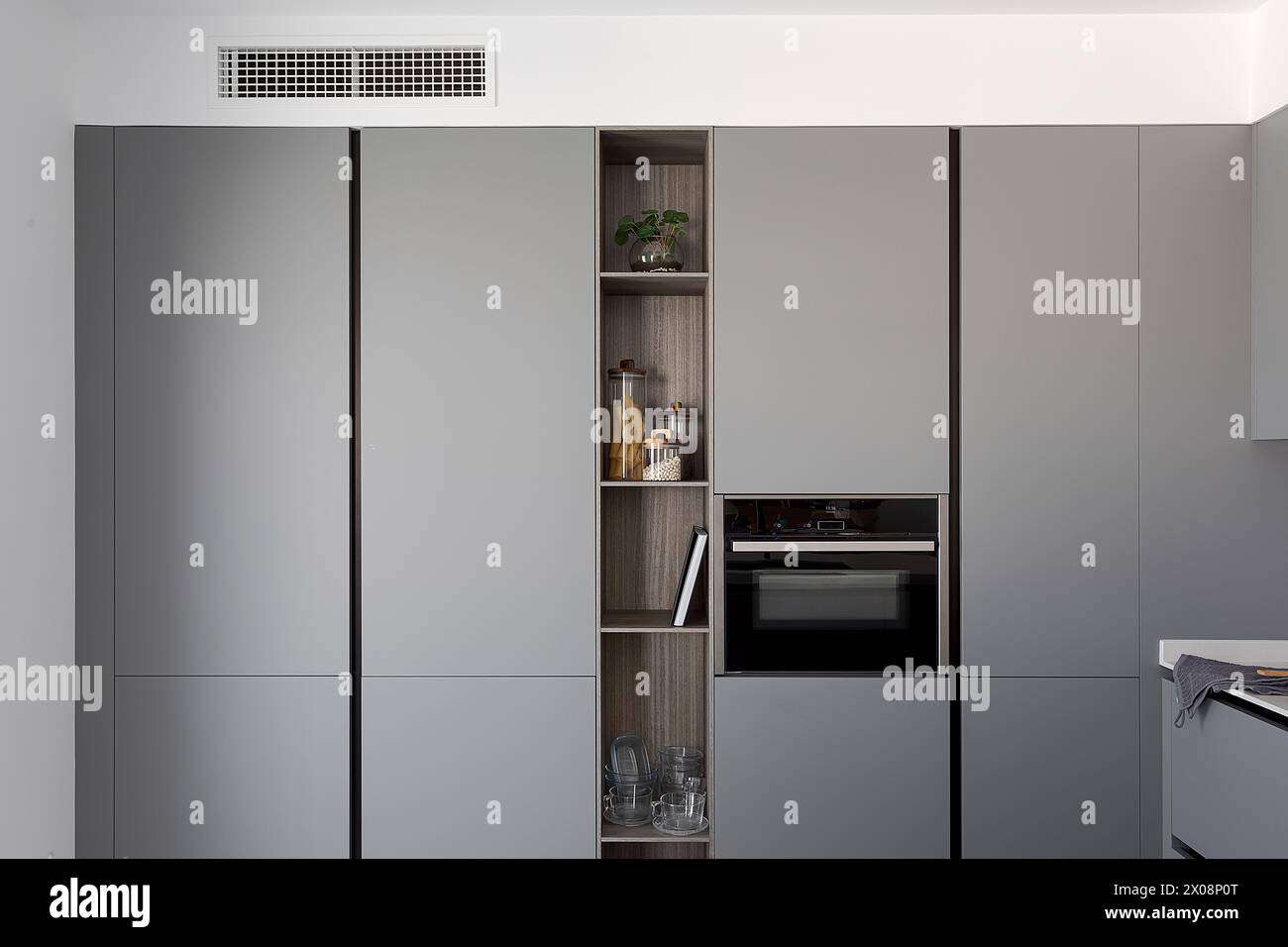 Modern kitchen interior featuring sleek grey cabinets and built-in ...