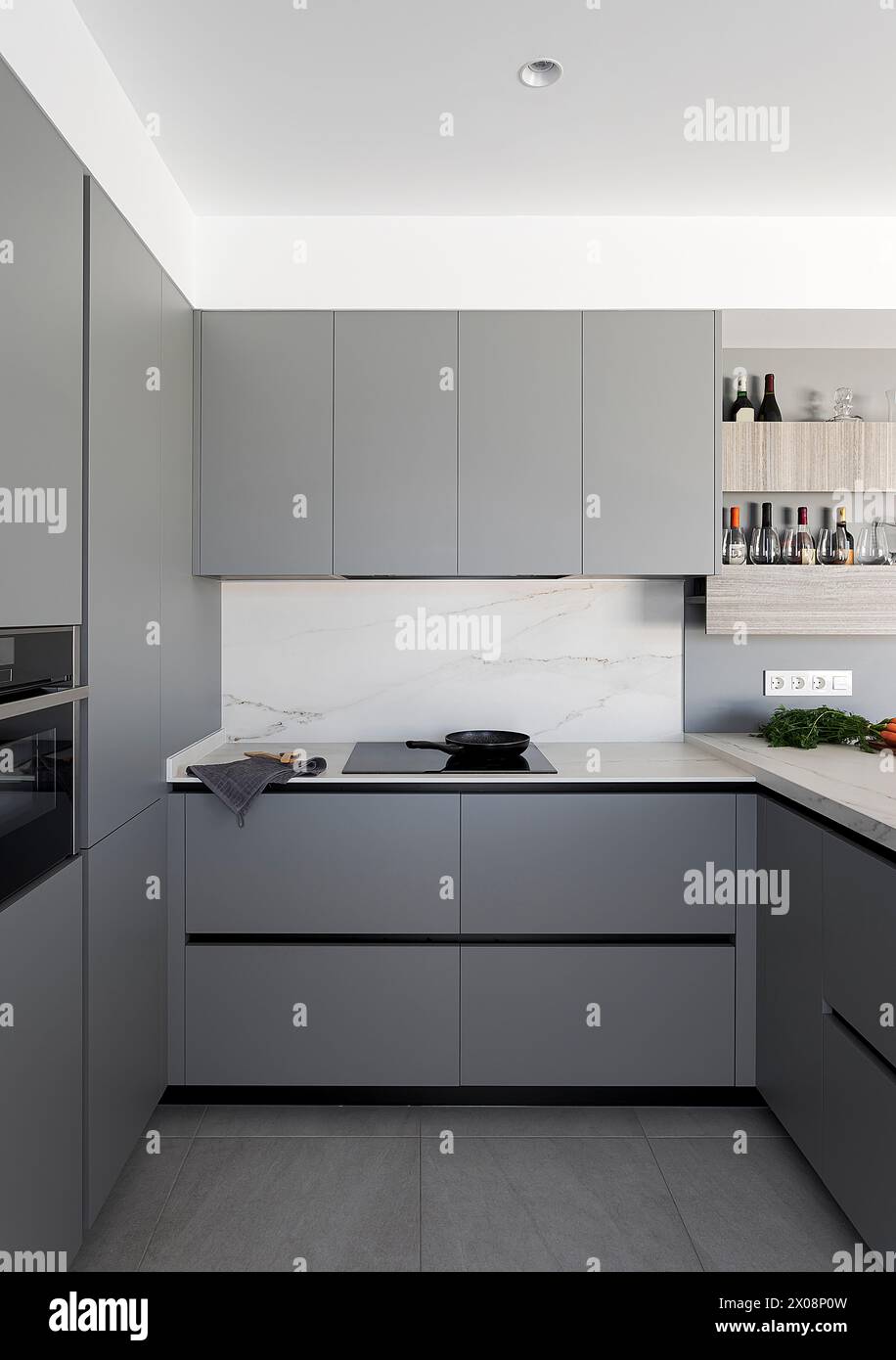 Contemporary kitchen design featuring gray cabinets, a white marble ...