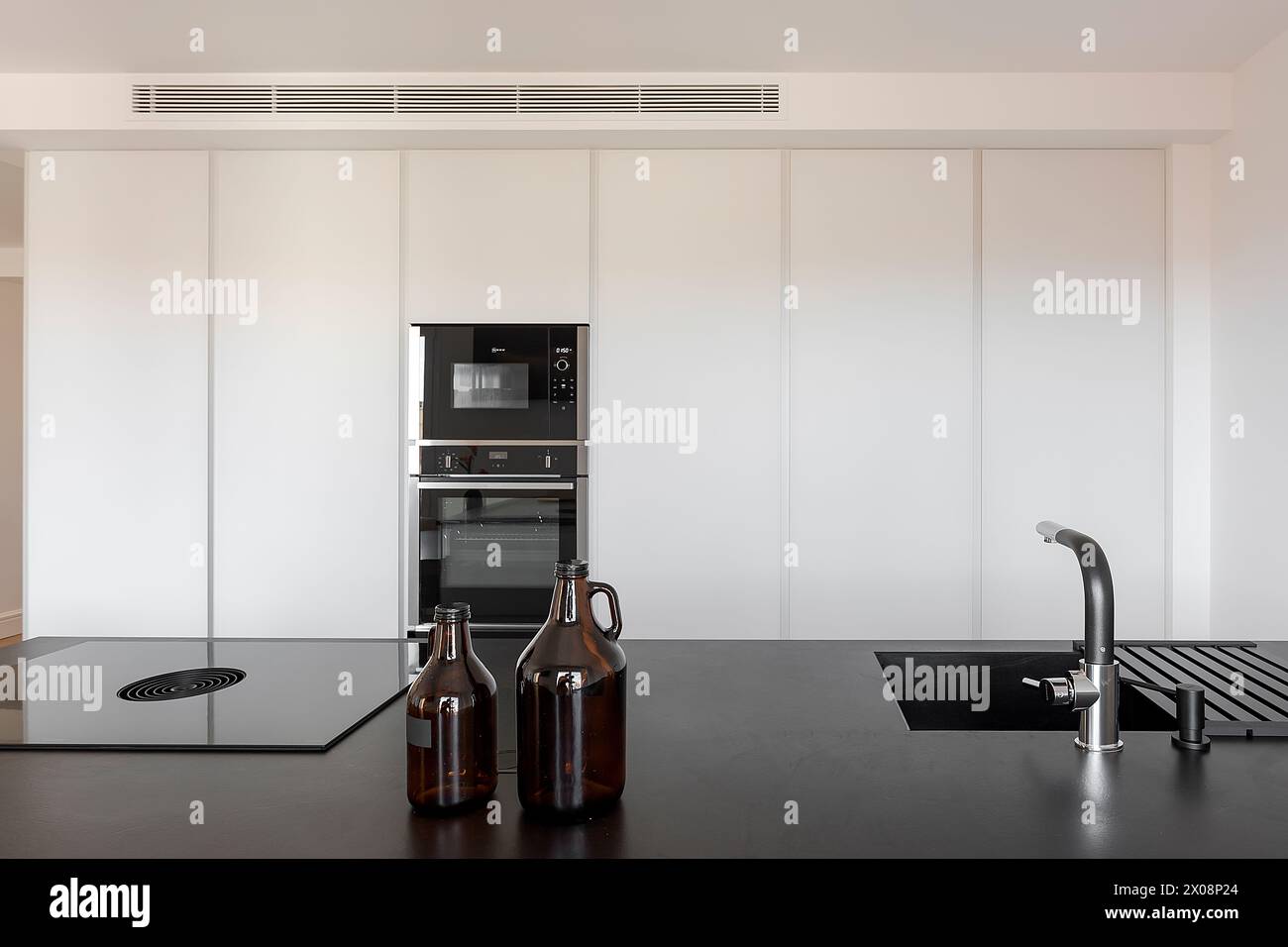 A sleek modern kitchen featuring integrated appliances and minimalist ...