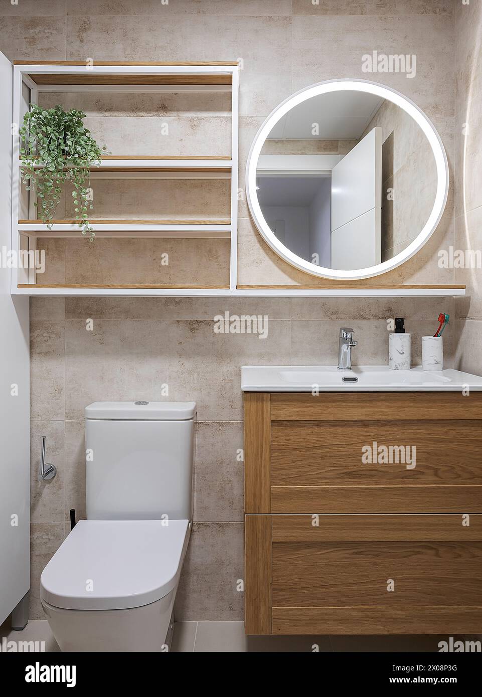 Modern bathroom corner with LED mirror and wooden features Stock Photo ...