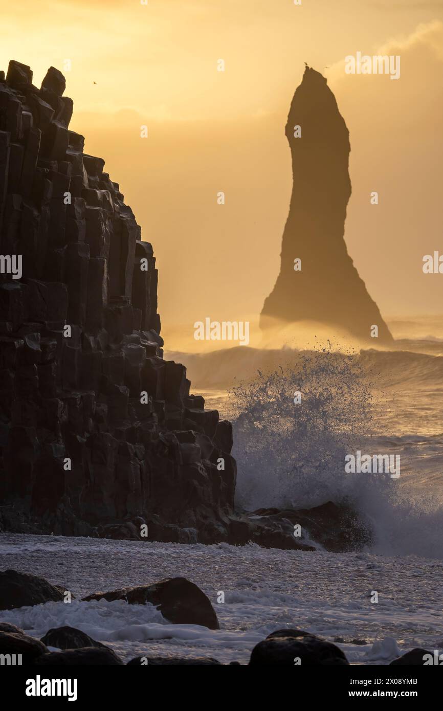 An ethereal Icelandic seascape featuring a towering sea stack ...