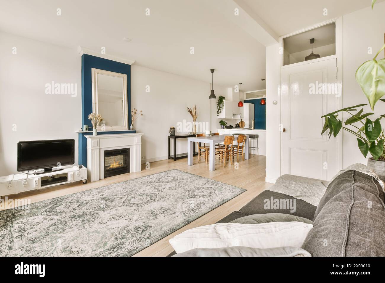 Contemporary living room with fireplace seamlessly transitions to a