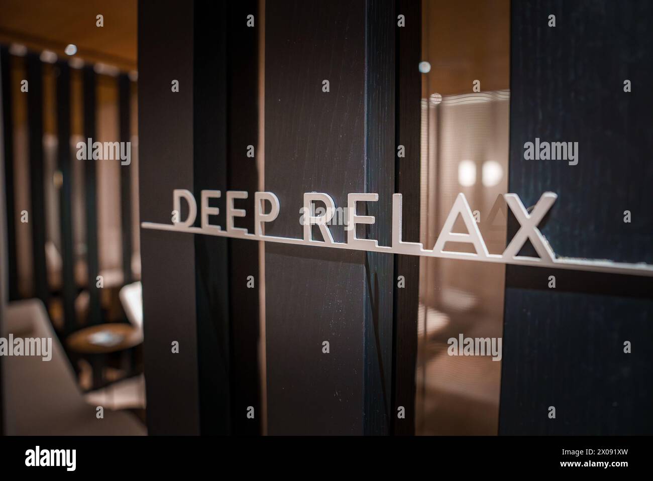 Luxury hotel glass door with DEEP RELAX etching in Zermatt Region Stock Photo