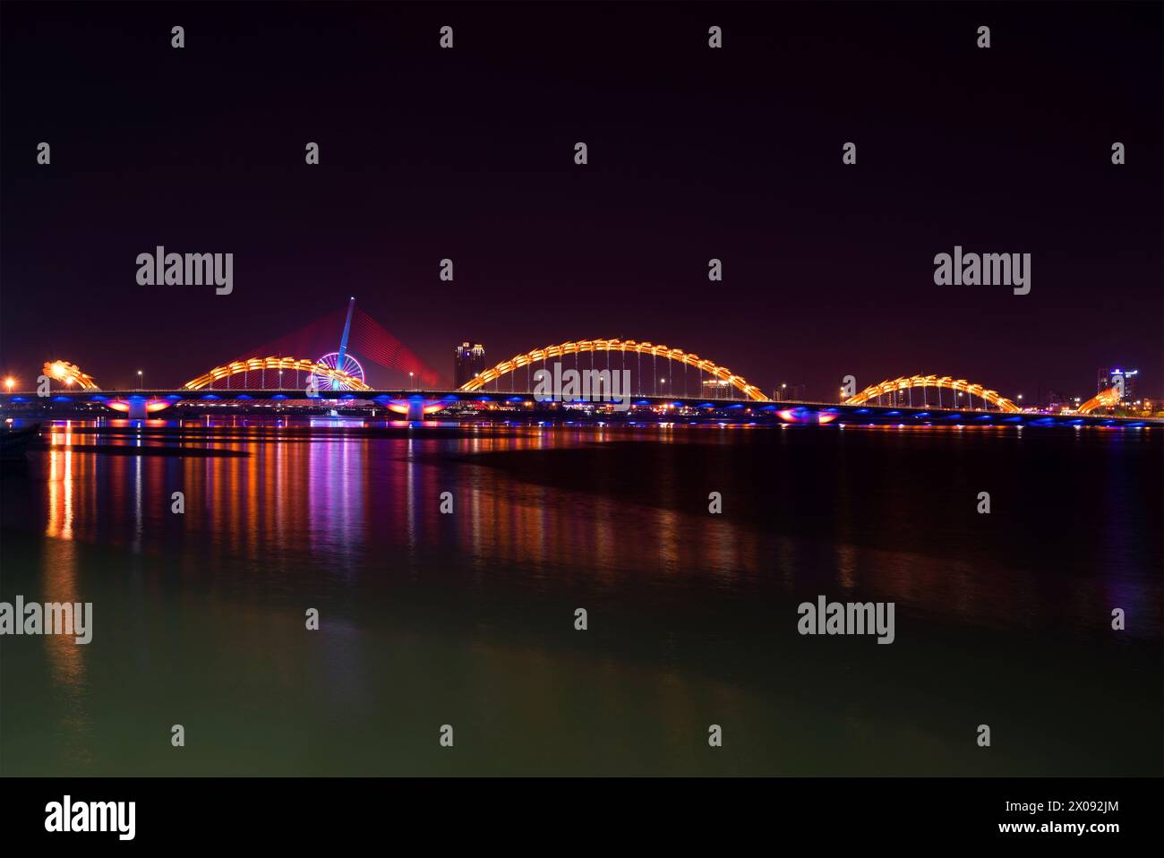The Dragon Bridge on the Han River in night illumination. Da Nang, Vietnam Stock Photo