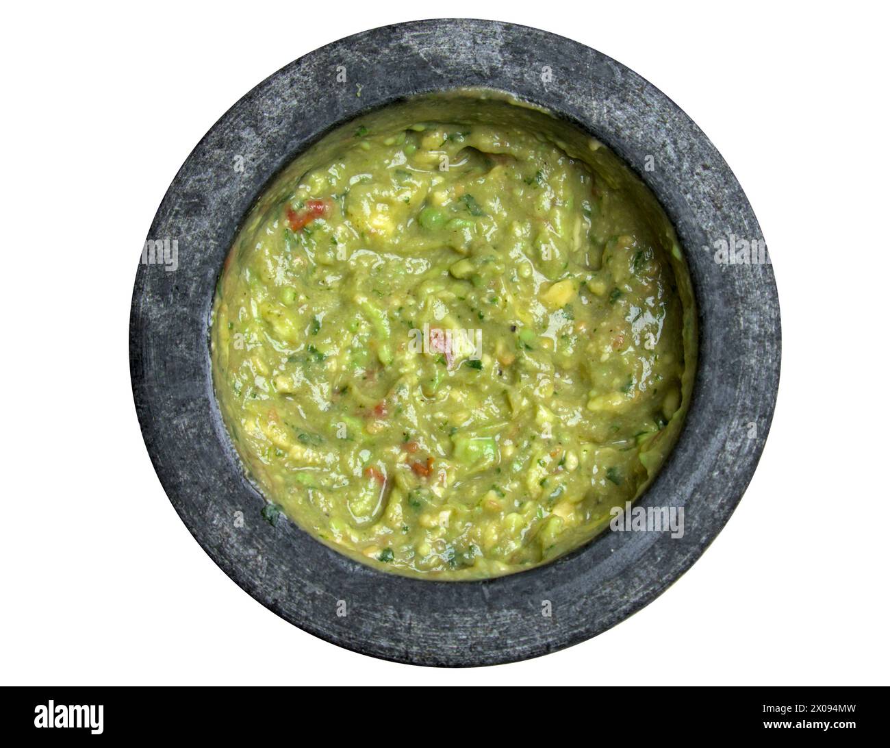 guacamole inside molcajete (traditional mexican mortar and pestle for grinding spices) avocado