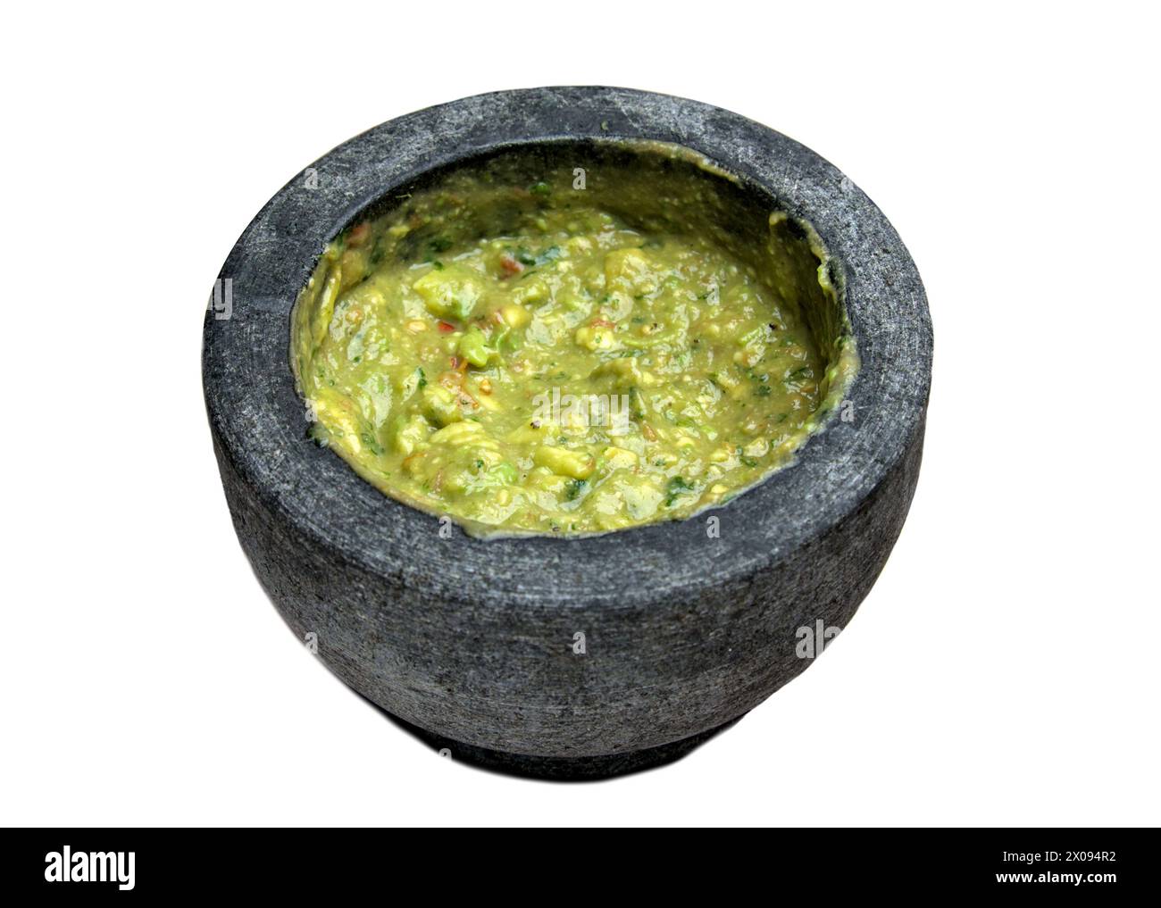 guacamole inside molcajete (traditional mexican mortar and pestle for grinding spices) avocado