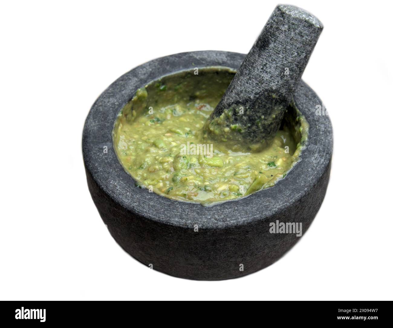 guacamole inside molcajete (traditional mexican mortar and pestle for grinding spices) avocado