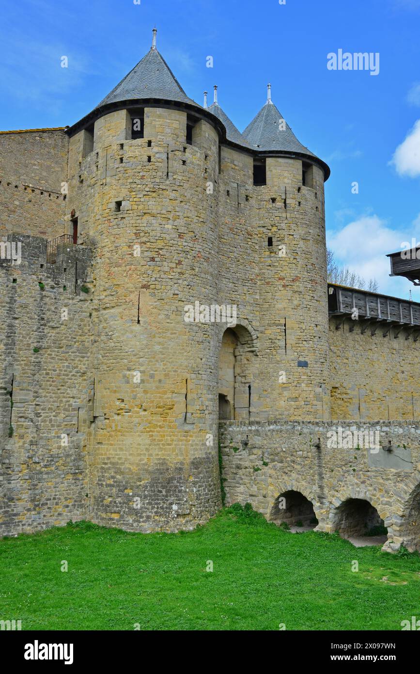 The medieval walls with hordings, bridge over moat and towers of the fortified town of UNESCO listed Carcassonne in the South of France Stock Photo
