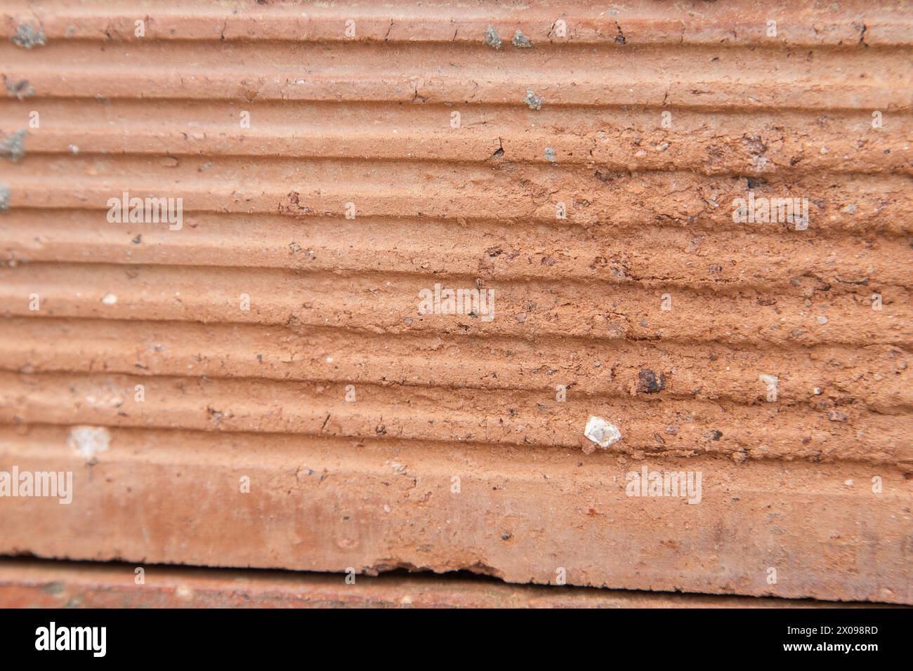Detail of old, damaged orange tile. Textured background image. Stock Photo