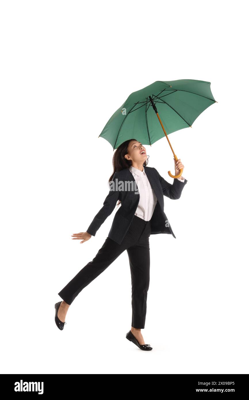 Funny Asian businesswoman with umbrella isolated on white background Stock Photo