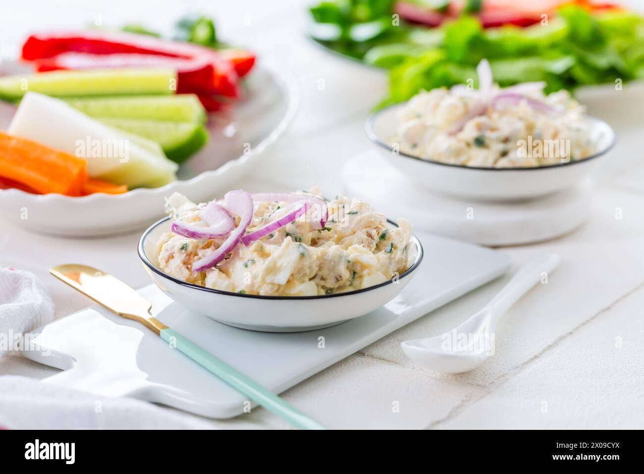 Fish and egg paste or salad with raw snack vegetables, healthy snack Stock Photo