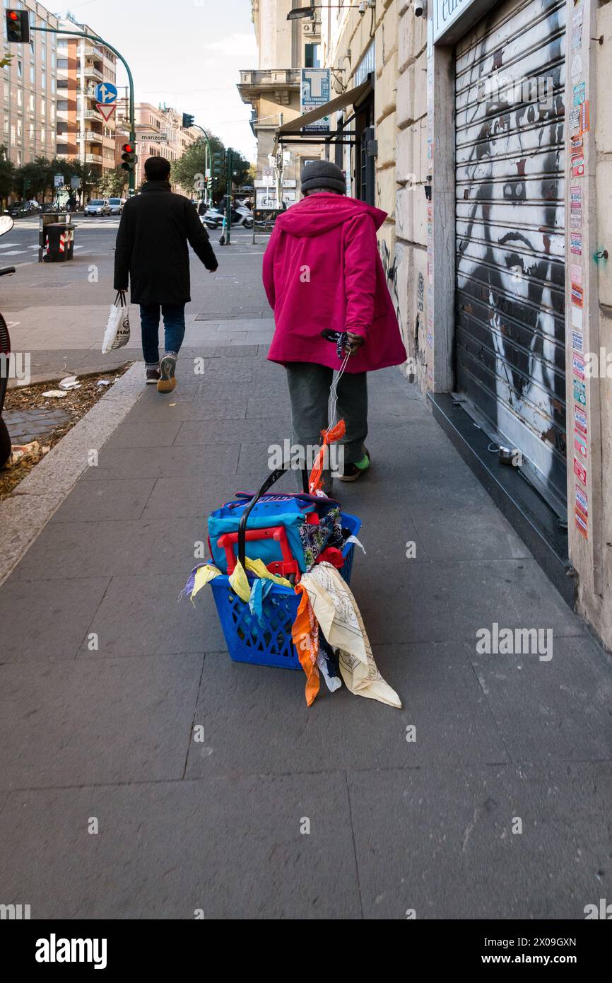 Italy, Rome: a homeless man walks dragging his belongings behind him Stock Photo
