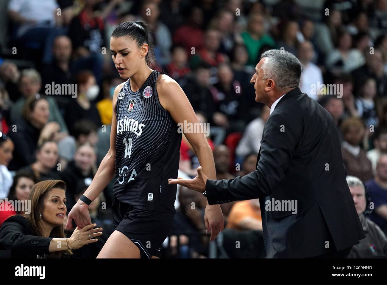 Besiktas coach Aziz Akkaya (right) speaks to player Tijana Krivacevic ...