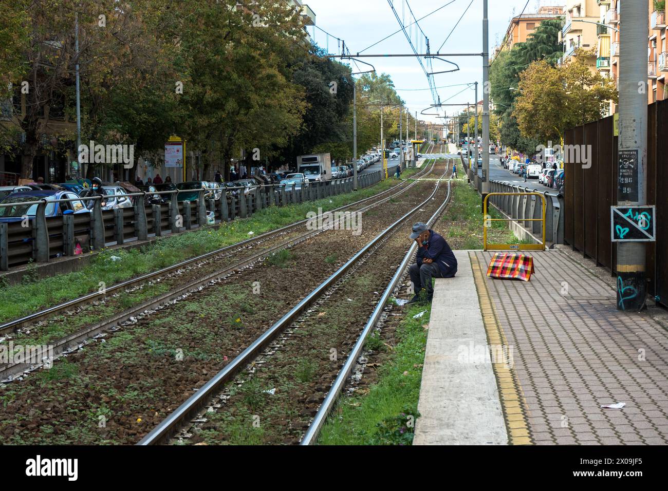 Italy, Rome: a lonely man, sitting on the platform of the Torpignattara train station Stock Photo