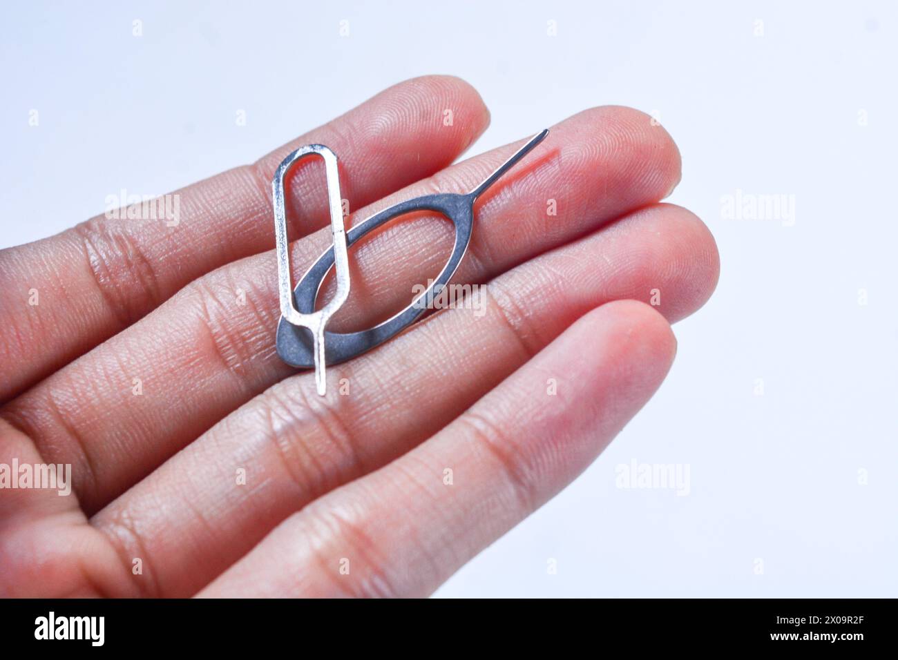 Close up of the "sim ejector" sim card opening tool inside a cell phone