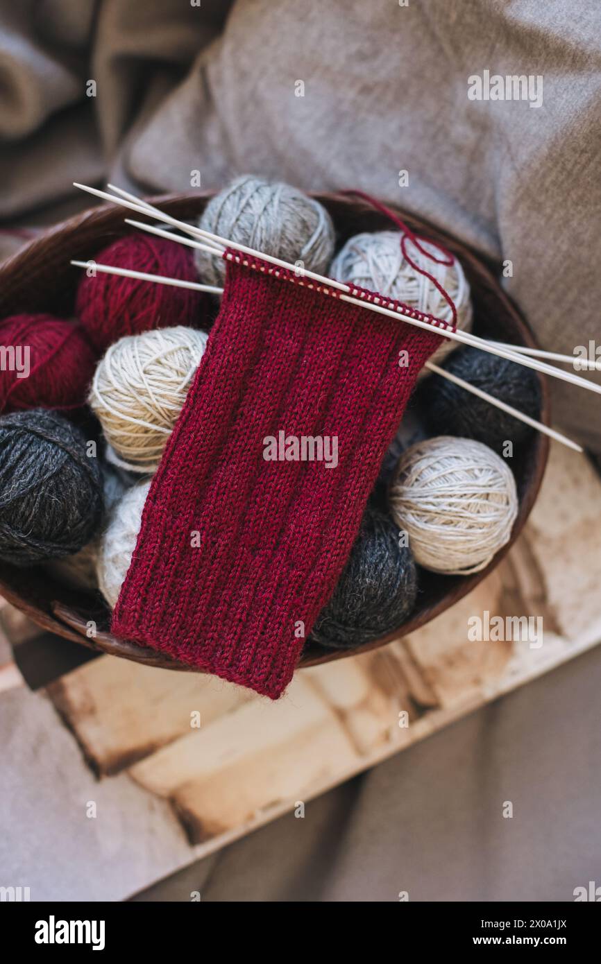Hand knitted socks with needles and yarn ball. Concept for handmade and hygge slow life. Stock Photo