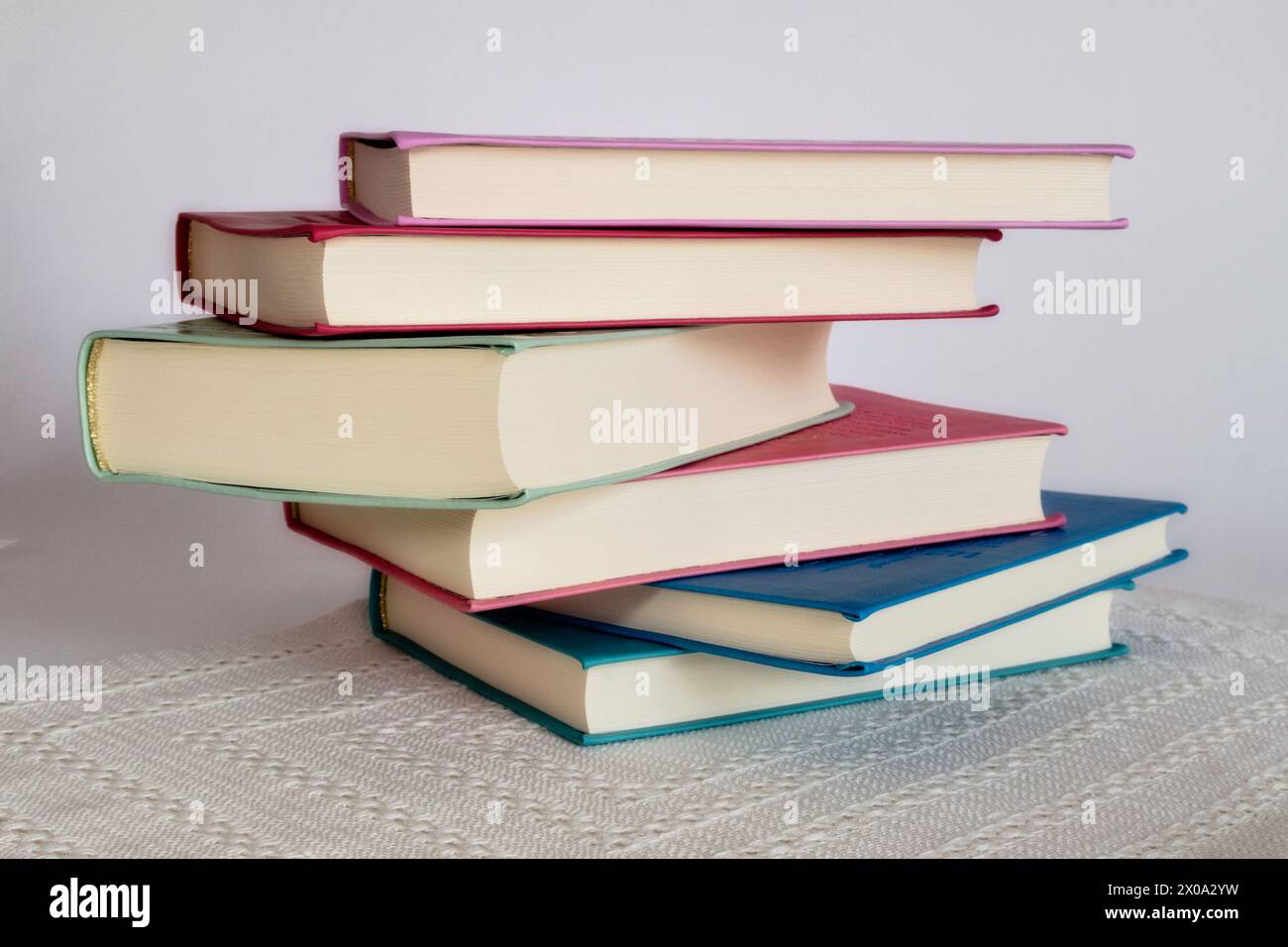 Hardback Books Stacked on White Background, 2024, Stock Photo