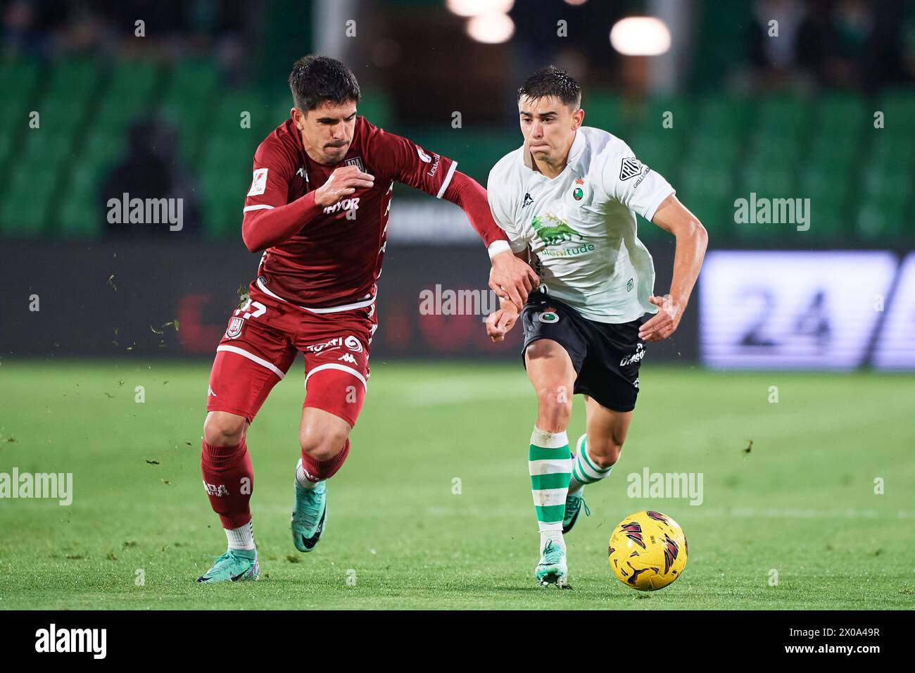 Mario Garcia of Real Racing Club compete for the ball with