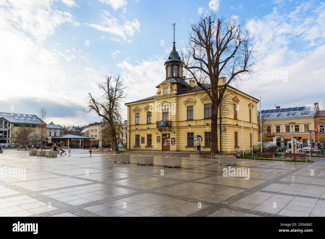 Nowy Targ, Poland - April 6, 2024: View of the town hall building on the Market Square after rain Stock Photo