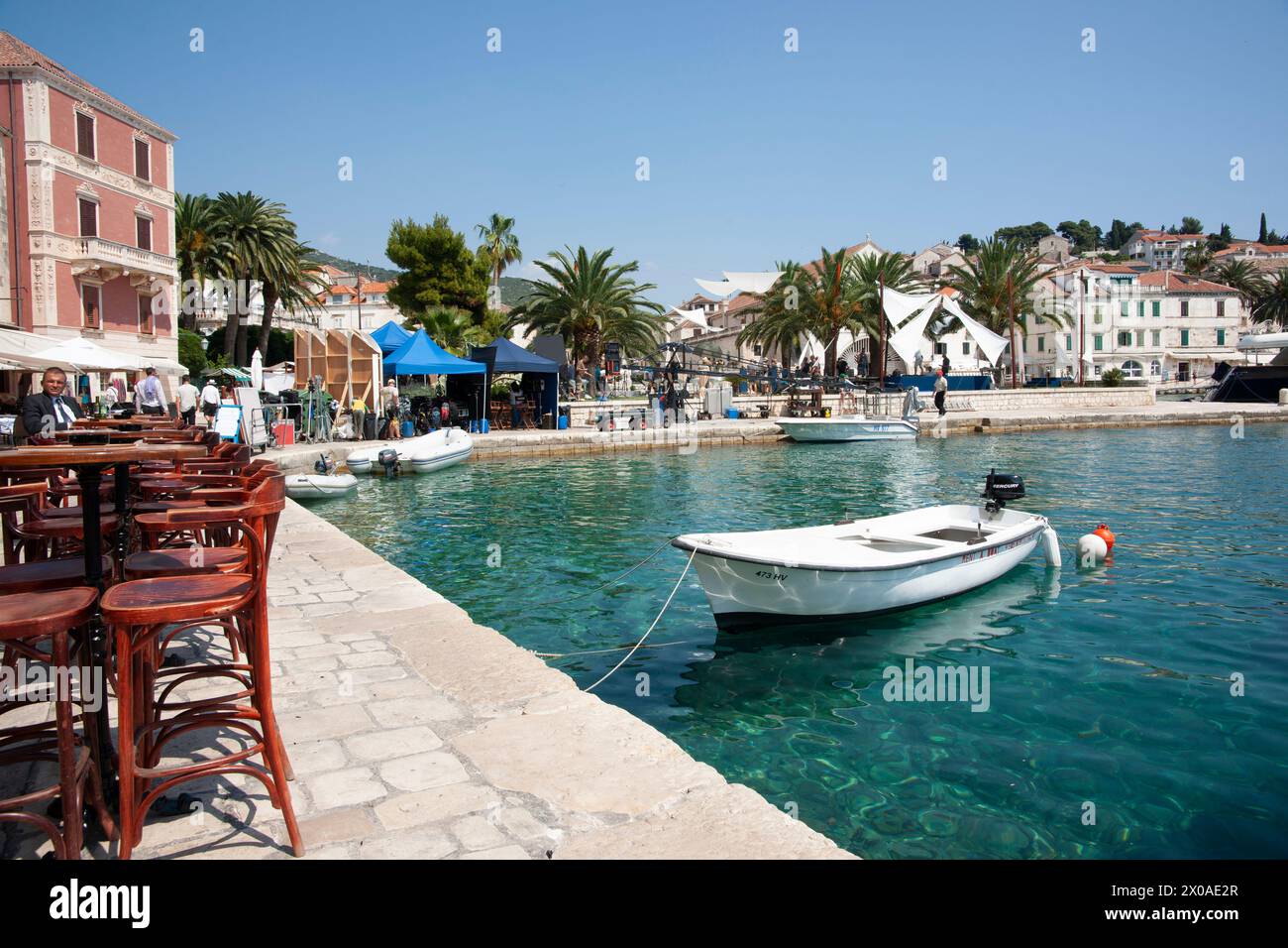 Hvar Croatia May 27 2011; Boats moored and people around picturesque Hvar waterfront. Stock Photo