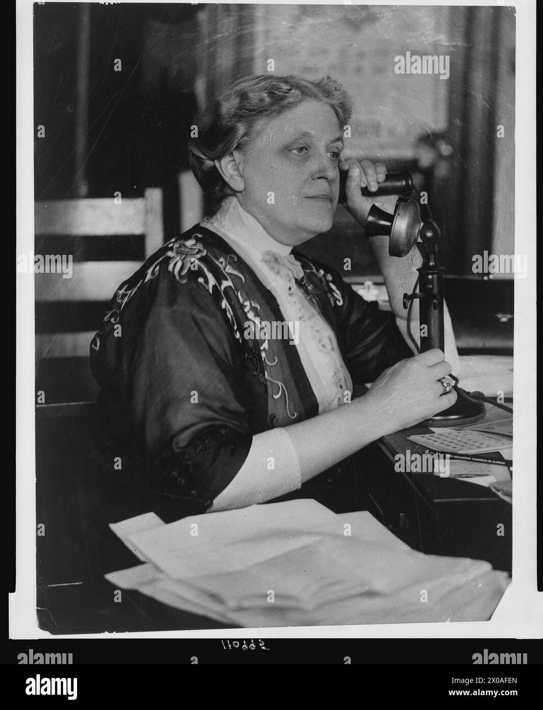 American suffragist leader Carrie Chapman Catt (1859-1947), talks on the telephone, no location, circa 1910. (Photo by National Photo Company Collection) Stock Photo