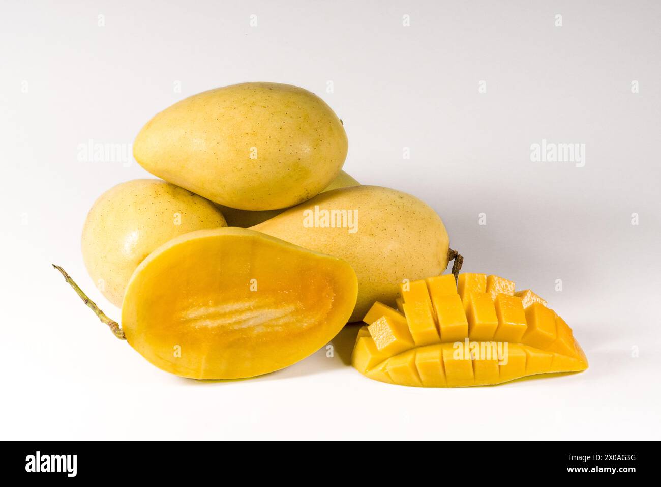 Mango fruits and mango cubes isolated on white background Stock Photo