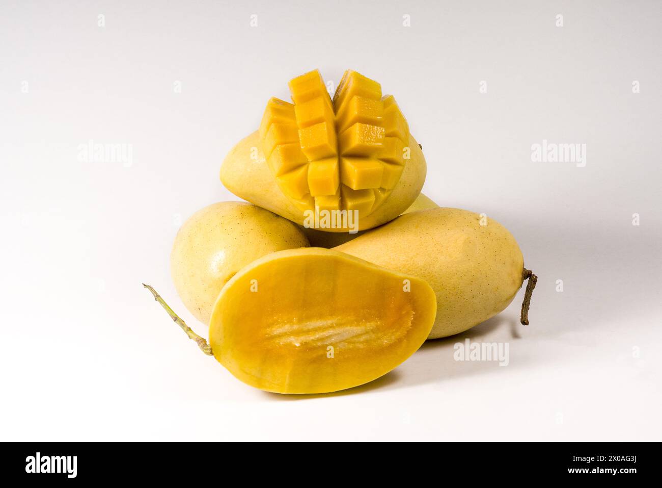Mango fruits and mango cubes isolated on white background Stock Photo