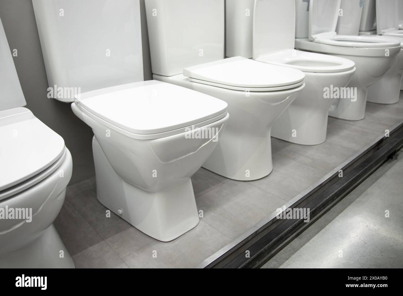 Ceramic toilet bowls of various shapes and sizes Stock Photo