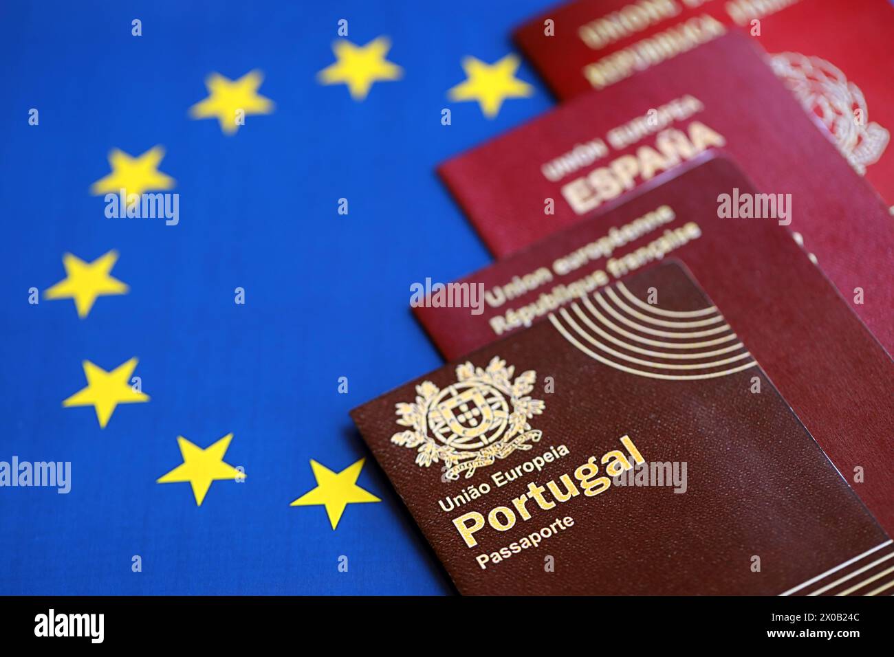 European union countries passports on blue EU flag close up. Portugal, Spanish, French and Italian passports Stock Photo