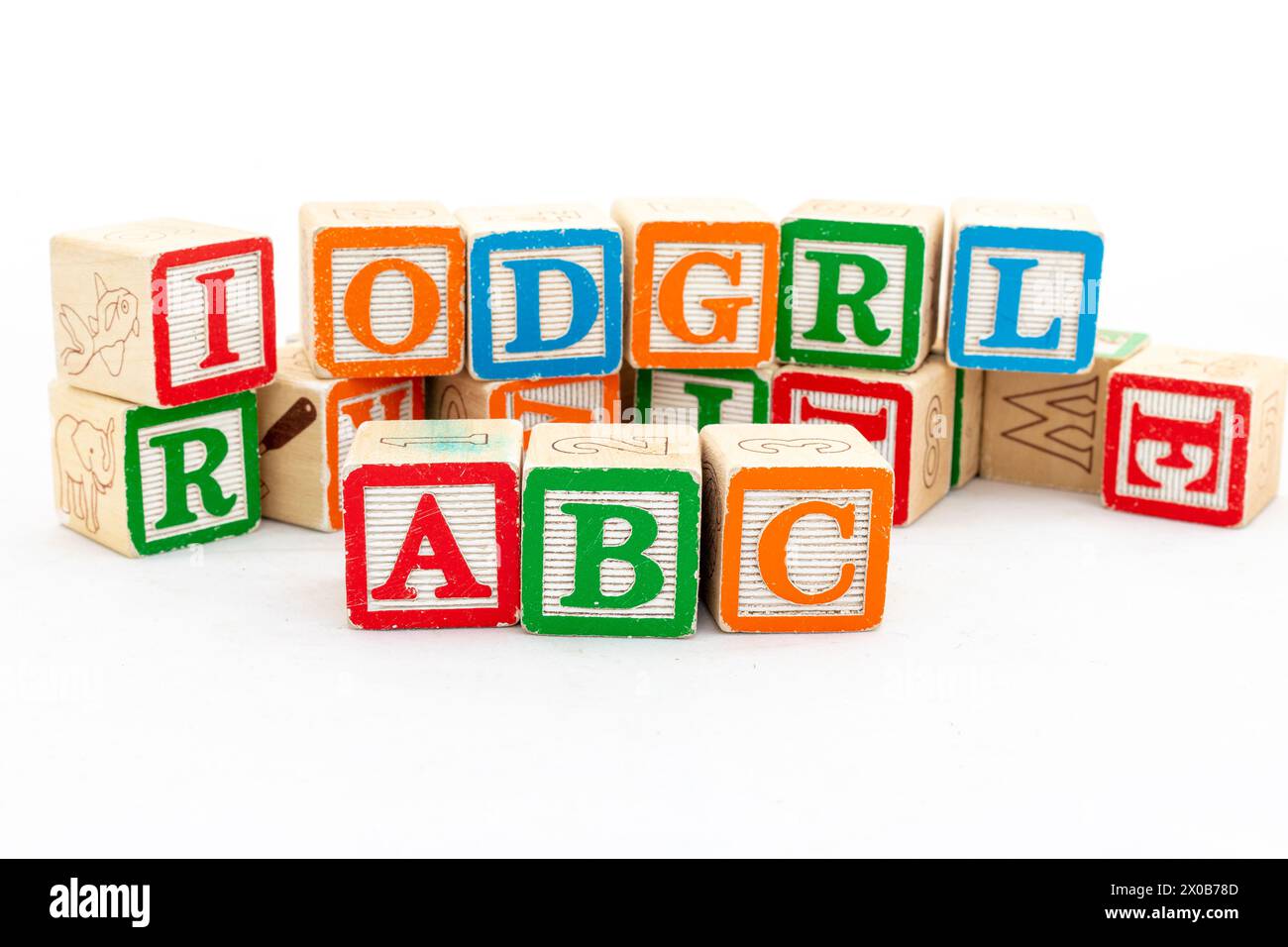 Multi-colored wooden letter blocks with ABC alphabets are selective focused isolated on white wood background Stock Photo