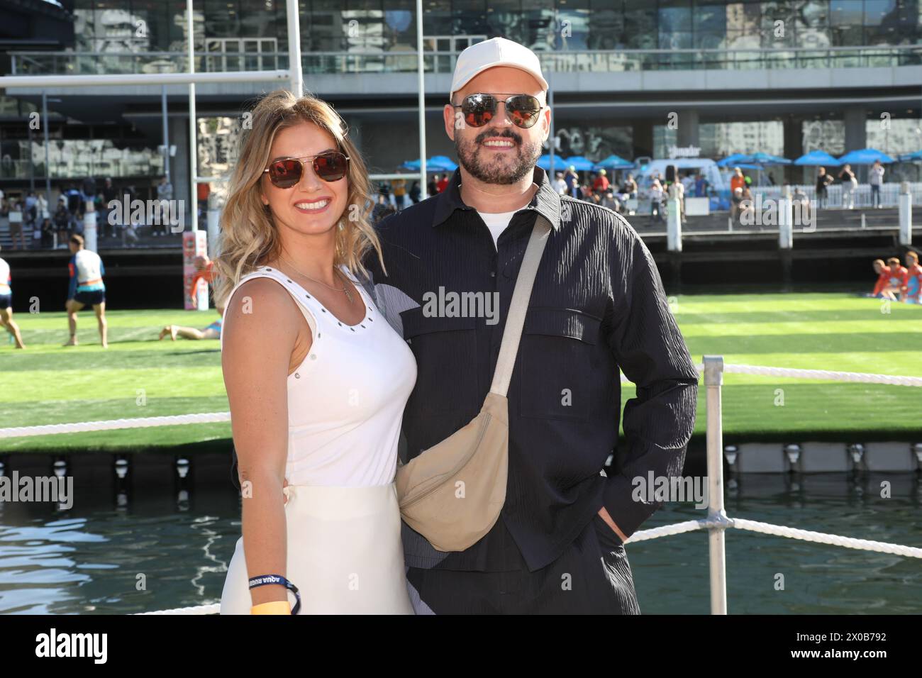 Sydney, Australia. 11th April 2024. The BSc Aqua Rugby Festival on a 30x30 metre floating pontoon at Darling Harbour. Pictured: CiCi Coleman (First Dates) and James Devlin (bartender on First Dates Australia). Credit: Richard Milnes/Alamy Stock Photo