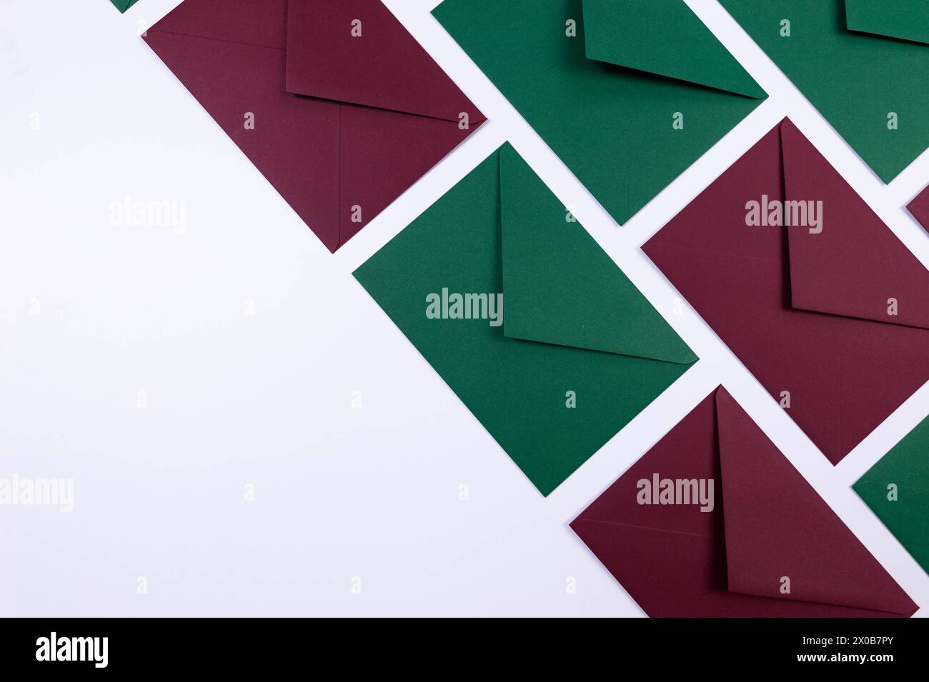 Top view of green and red envelopes on white background. Post flat lay. Copy space. Stock Photo