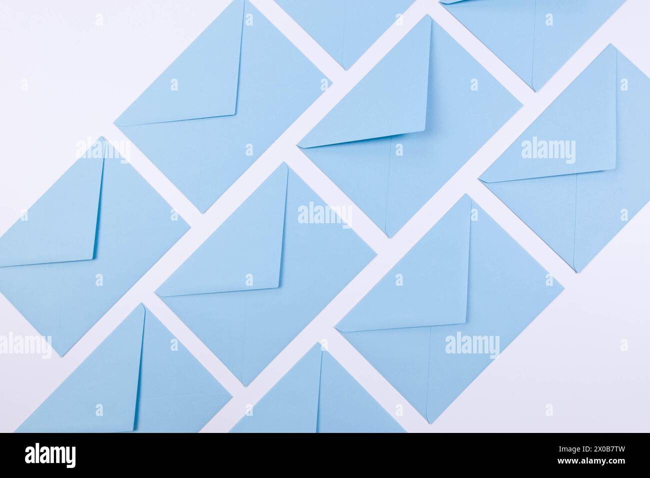Top view of light blue envelopes on white background. Post flat lay. Copy space. Stock Photo