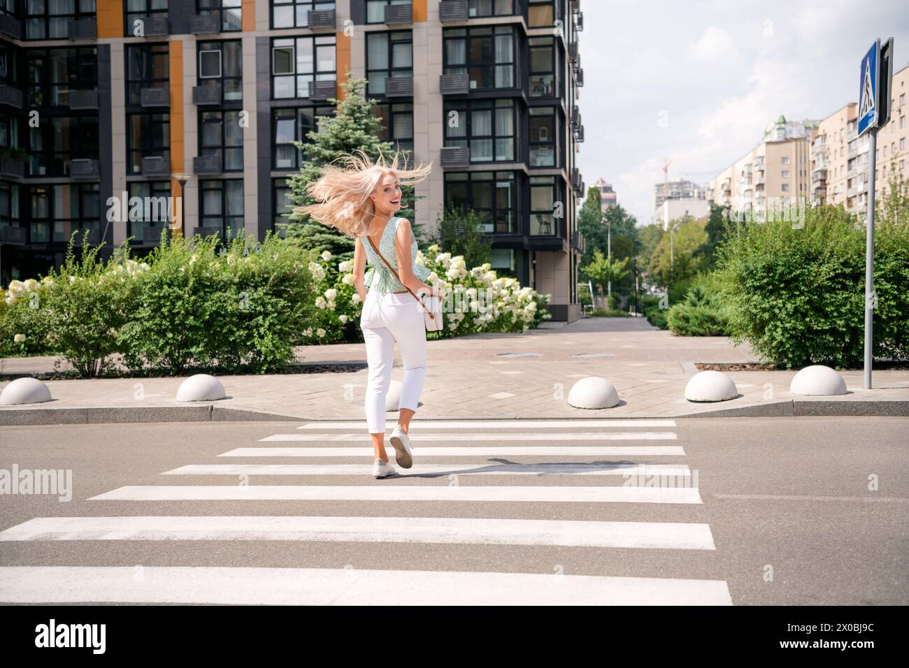 Rear view photo of cute adorable positive girl walking city street ...