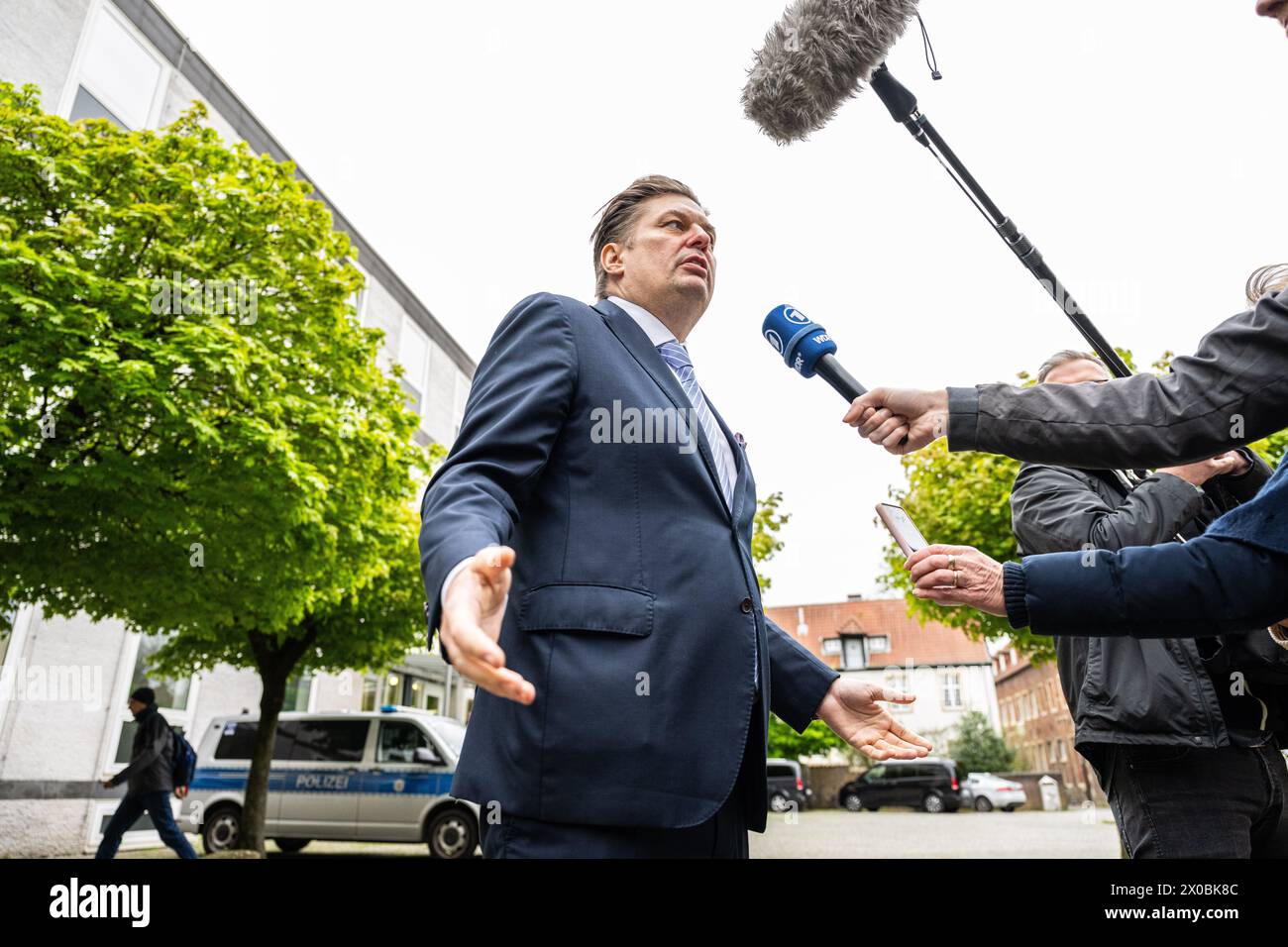 11 April 2024, North Rhine-Westphalia, Münster: Maximilian Krah (AfD), Member of the European Parliament, stands in front of the Higher Administrative Court in Münster and gives an interview to the journalists present during the continuation of the appeal proceedings regarding the dispute over the classification of the AfD by the Office for the Protection of the Constitution. The oral proceedings at the Higher Administrative Court of Münster in North Rhine-Westphalia will continue after the two hearings in mid-March. Photo: Guido Kirchner/dpa Stock Photo